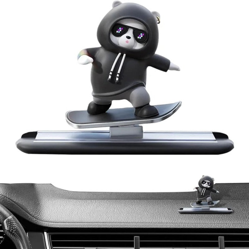 Panda figurine in a hoodie on a car dashboard with a white background